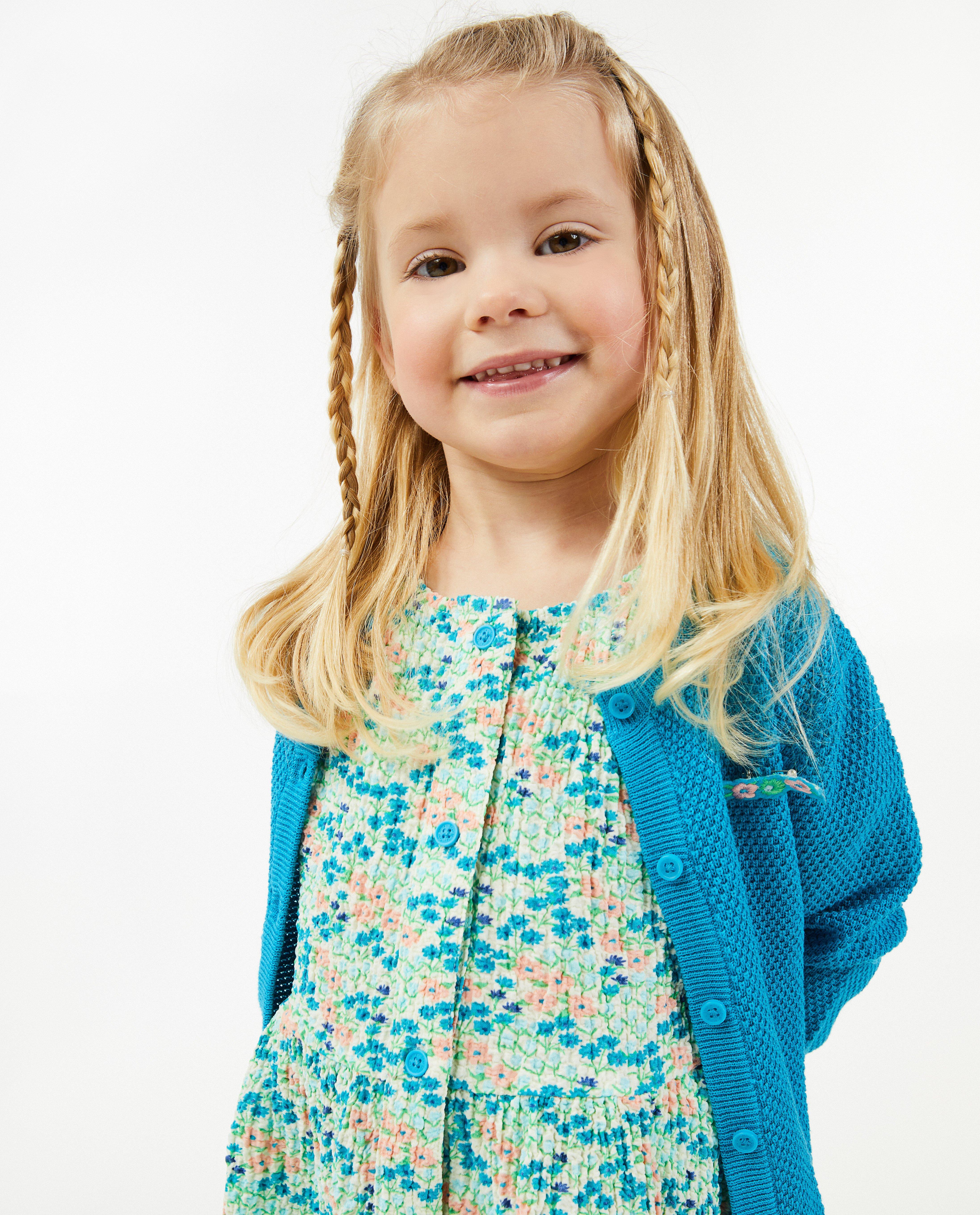Cardigans - Cardigan bleu avec une petite broche